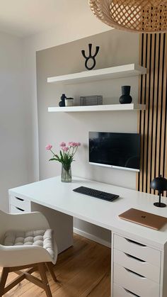 a white desk with a computer monitor and keyboard