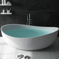 a white bath tub sitting on top of a bathroom floor