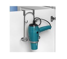 a blue hair dryer hanging from the side of a white wall next to a cup holder