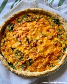 a quiche with cheese and spinach on top