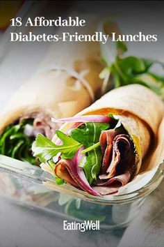 a wrap filled with meat and veggies on top of a table