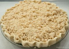 an uncooked pie sitting on top of a counter