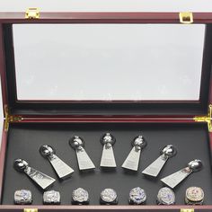 a display case with seven watches in it's opening and the lid opened to show them