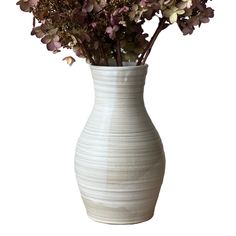 a white vase with purple flowers in it