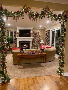 the living room is decorated for christmas with garlands and decorations on the fireplace mantel