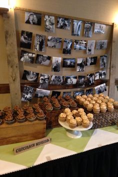 a table topped with cupcakes and muffins next to pictures on the wall