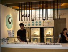 two people standing in front of a display case