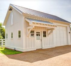 a small white house with a metal roof