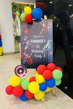 a birthday decoration with balloons and a sign