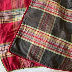 two red and green plaid bedspreads laying next to each other