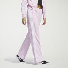 Comfort and style unite with these women's velour 3-stripe tracksuit pants. Designed with a wide leg at the bottom hem and snaps, wear the pant open or tapered based on your style. Featuring three-stripes at the side leg and an elevated gem branding at the wearers left leg, this pant mixes with your favorite pieces and features primegreen trims, echoing our commitment to sustainability.Front Style: Flat FrontClosure Type: DrawstringFit: Regular FitPockets: 2 Front Zip PocketsRise: Mid RiseSupport: Light SupportFiber Content: 100% Recycled PolyesterFabric Description: VelourInseam: 29 1/2 InLeg Style: Straight LegCare: Tumble Dry, Machine WashCountry of Origin: Imported Adidas Three Stripes Pants, Full Length Pants With Side Stripes, Adidas Wide Leg Casual Sweatpants, Adidas Casual Wide Leg Sweatpants, Adidas Casual Wide-leg Sweatpants, Adidas Sporty Wide Leg Bottoms, Adidas Sporty Wide Leg Pants, Adidas Sporty Wide-leg Pants, Adidas Sporty Wide-leg Bottoms