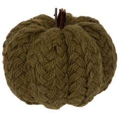 a green knitted pumpkin sitting on top of a white surface