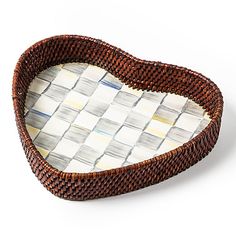 a woven heart shaped tray on a white background