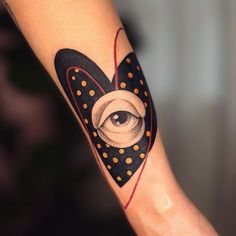 an eye tattoo on the arm with dots and circles around it, in black and white