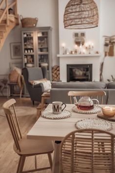 a living room filled with furniture and a fire place next to a stair case in front of a fireplace