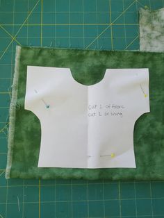 a piece of paper that has been cut out to make a top for a shirt