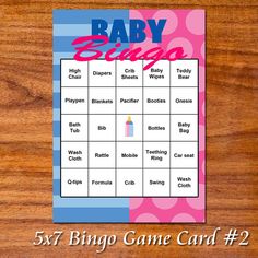 a baby shower game card on a wooden surface with the words, 5x7 bingo game card