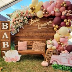 an outdoor baby shower with balloons and decorations