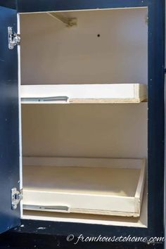 an open metal box with two shelves in it