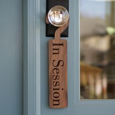 a wooden sign that says tus session hanging on the side of a blue door