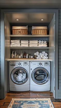 a washer and dryer in a laundry room with baskets on the shelves above