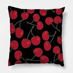 a black pillow with red cherries on the front and back, all over it