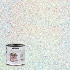 a can of white paint with sprinkles on the wall in front of it