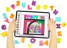 two hands are holding an ipad with the words story time on it, surrounded by colorful letters