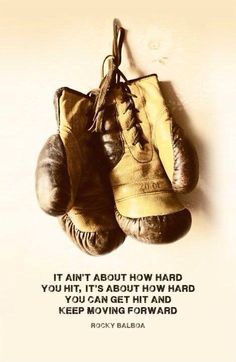 two boxing gloves hanging on a wall with a quote from rocky balba about how hard you hit, it's about how hard you can get hit and keep moving forward