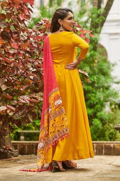 Umbre Pichwai Suit Set, where elegance meets a touch of enigma! The classic Yellow hue gets a playful upgrade with the pichwai pattern, which is as captivating as a starlit night. The handwork adds a sprinkle of glamour, while the linen dupatta floats like a whisper of intrigue, completing the look. (Side zip attached)Size small 36Dress Fabric- Honey silkDress Length- 52inch Traditional Yellow Floor-length Dress, Traditional Yellow Dress For Navratri, Yellow Anarkali Dress With Cutdana Detailing, Yellow Anarkali Dress With Cutdana, Yellow Cutdana Anarkali Dress, Yellow Traditional Drape Dress For Eid, Yellow Bollywood Dress With Traditional Drape, Traditional Drape Yellow Dress For Eid, Yellow Bollywood Sharara