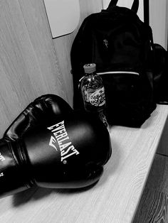 two boxing gloves and a backpack sitting on a counter