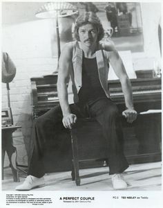 an old black and white photo of a man sitting on a chair in front of a piano