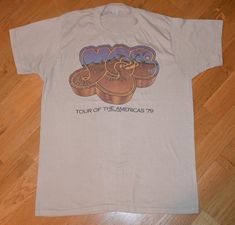 1979 YES tee shirt  Size: Large Brand: Unknown  Material: 50% cotton / 50% polyester   Chest: 19.5 inches  (measured across the shirt from armpit to armpit) Length: 27 inches  (measured from top to bottom starting at the back collar) Condition: GREAT broken-in vintage condition w/ no stains but has one tiny hole **Any reasonable offers will be considered** DOMESTIC SHIPPING    $0.00  FREE INTERNATIONAL SHIPPING   $20.00 Canada $25.00 Rest of the World I have an enormous vintage tee shirt collect Vintage T Shirts 70s, Jon Anderson, Vintage Tee Shirts, Vintage Tee, Band Tees, Vintage Tees, Vintage Tshirts, Tee Shirt, 1970s