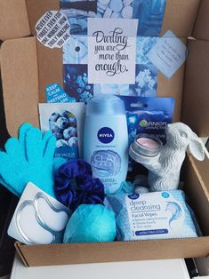 an open box containing baby items such as mitts, gloves, and soaps