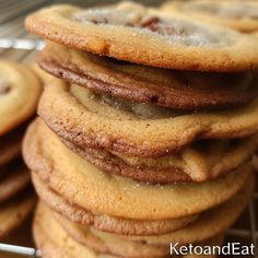 a pile of cookies sitting on top of a cooling rack next to eachother