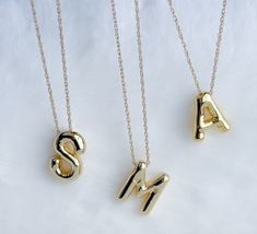 Balloon letter necklace Make a statement that is uniquely yours with our personalized initial necklaces. Choose your initials or those of someone special, and let these necklaces become an emblem of cherished connections and memories. The perfect blend of sentiment and style. Each necklace is made with high-quality materials to ensure durability.  MATERIAL AND SIZE 18k gold filled chain  Gold plated balloon letter Size pendant: 2.3cm Length chain: 45cm or 18 inches If you have questions about th Mother's Day Initial Pendant Necklace With Letter Beads, Mother's Day Initial Necklace With Letter Beads, Personalized Tan Pendant Necklace, Initial Pendant Charm Necklace With Letter Beads For Gift, Gift Initial Pendant Charm Necklace With Letter Beads, Gift Charm Necklace With Initial Pendant And Letter Beads, Tan Initial Pendant Charm Necklaces, Initial Pendant Name Necklace, Monogram Initial Pendant Name Necklace