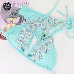 "Oh, what a bright and stylish bikini! This Turquoise Designer Swimwear will be your perfect decoration and complement! The incredible brilliance of the crystals of this bikini will cover the whole audience. Excellent tailoring will give confidence combined with a beautiful bikini stage look. So everyone will be Amazed by the beauty of your Crystal Bikini! ❤ Fully lined ❤ Adjustable drawstring triangle top with push up ❤ Beautiful sparkle appearance ❤ Hand-applied crystals ❤ Spandex material ❤ H Turquoise Halter Neck Swimwear For Poolside, Turquoise Halter Neck Swimwear For Swimming, Triangle Top Swimwear For Beach Party, Triangle Top Swimwear For Beach Season Party, Party Triangle Top Swimwear For Beach Season, Fitted Turquoise Swimwear For Beachwear, Turquoise Triangle Top Swimwear For Swimming, Turquoise Triangle Top Beachwear, Turquoise Triangle Top Swimwear For Pool