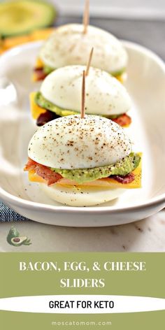 bacon, egg, and cheese sliders on a plate with avocado in the background