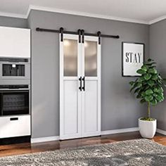 a living room with gray walls and white doors