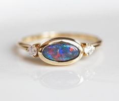 Gorgeous black opal & diamond ring. One of a kind ring, available in 14k yellow gold as seen online. A unique engagement or wedding band. Please select ring size from the drop-down menu. The finish can be brushed, satin or polished. Please leave us a note with the selected finish. If you have any questions, please contact us. If you would like to have other gemstones instead of diamonds/opals please contact us before purchase regarding pricing. Item details: genuine black opal diamonds - 2.3 Black Opal Engagement Ring, Australian Opal Jewelry, Opal And Diamond Ring, Opal Jewellery, Gold Body Chain, Opal Diamond Ring, Blue Opal Ring, Black Opal Ring, Ring Rosegold