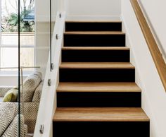 a set of stairs leading up to a living room with a couch in the background