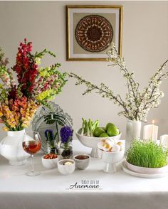 a table topped with vases filled with different types of flowers and plants next to each other