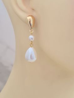 Introducing these gorgeous shell coated pearl drop earrings with gold plated teardrop studs.  Elegant and suitable for your special occasion. These earrings measure just over 1.5in/4.2cm. The earrings will arrive in a bag ready for giving. This item ships from the UK within 1 working day. Pear-shaped Pearl Charm Wedding Earrings, Teardrop Pearl Charm Earrings For Anniversary, White Dangle Clip-on Pearl Earrings, White Dangle Pearl Clip-on Earrings, White Pearl Dangle Clip-on Earrings, Teardrop Pearl Chain Earrings For Anniversary, Gold Teardrop Earrings With Pearl Charm, Gold Teardrop Earrings With Pearl Drop For Anniversary, Anniversary Teardrop Pearl Chain Earrings