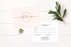 the wedding stationery is laid out on top of a white table with greenery