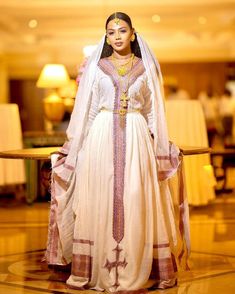 Graceful Blush Bloom: Modern Menen Fabric in Habesha Kemis – TheEthiopianStore Wedding Dress With Woven Motifs For Transitional Season, Transitional Wedding Dress With Woven Motifs, Handloom Dress For Wedding And Eid, White Dresses With Weaving Work For Traditional Ceremonies, Wedding Long Sleeve Dress With Woven Motifs, Long Sleeve Wedding Dress With Woven Motifs, Handloom Fitted Wedding Dresses, Elegant Handloom Dress For Eid, Traditional Wedding Dress With Weaving Work