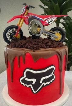 a red and brown cake with a motorcycle on top