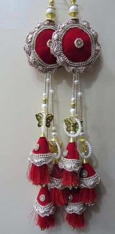 Indian Long Lehenga Red And Golden Beaded Fancy Tassels | Sewing Sari Tassel Dress Material | Home Decor Decorative HangingHandmade Hanging/tasselsMaterial:Silk, Thread, MotifsPackage Contents: 4Key Features:Embroidery art workThis  is good match with both Indian and western outfits and are superb for wedding and festive parties.This would be best complement to your designer saree, lenhga or any other kind of dress.This is the combination of traditional and modern embroidery work.We welcome whol Long Lehenga, Tassels Fashion Clothing, Fancy Tassels, Fancy Face Mask, Tassels Tutorials, Designer Tassels, Saree Tassels Designs, Tassel Crafts, Boat Neck Blouse Design