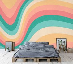 a bed sitting in front of a colorful wall