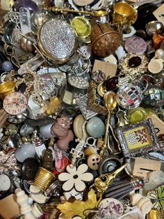 a pile of assorted items including brooches and necklaces are piled on top of each other