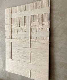 a white wall hanging on the side of a wall